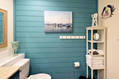 a bathroom with a blue wall with boats in the water at 3170 S Peninsula Drive in Daytona Beach