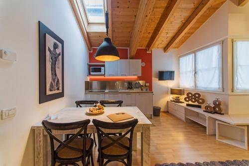 a kitchen with a table and chairs in a room at La Casa di Trento in Trento