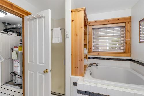 a bathroom with a bath tub in a room at Peaceful Cottage in Gearhart