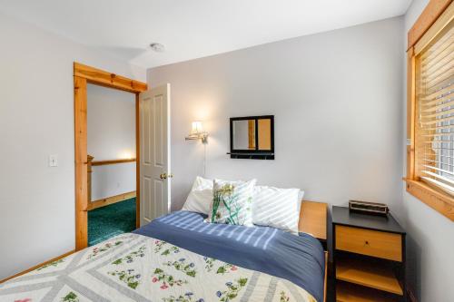 a small bedroom with a bed and a window at Peaceful Cottage in Gearhart