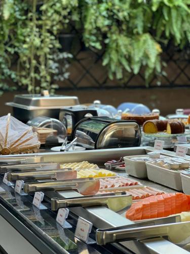 a buffet of different types of food on a table at Hotel Oeste Plaza in Andradina