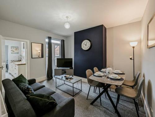 a living room with a couch and a table at Derrington House - By Sigma Stays in Crewe