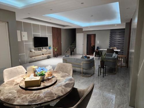 a large living room with a table and a couch at Spacious 5-bedroom, 4-bath townhouse in Legazpi City in Legazpi