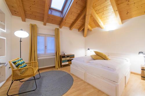 a bedroom with a large white bed and a table at La Casa di Trento in Trento