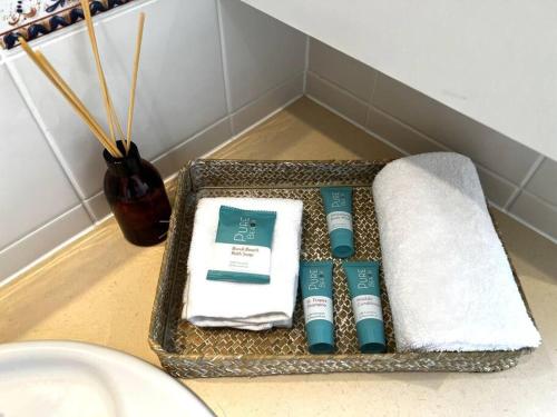 a basket filled with towels and towels in a bathroom at Beach Front Ocean View 3 Bedroom Apartment in Maroochydore in Maroochydore