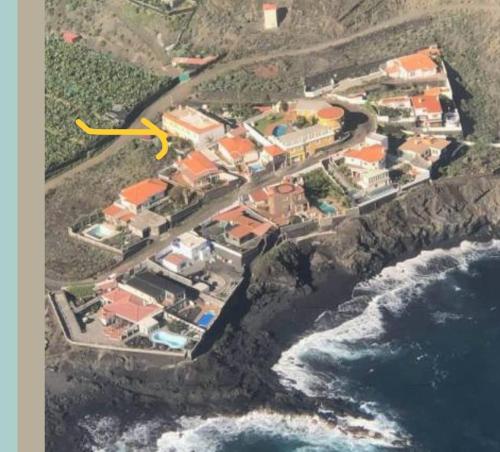 a yellow object is flying over a group of houses at Vivienda Miramar in Mazo