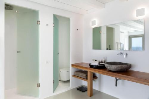 a bathroom with a sink and a mirror at She Mykonos - The Residency in Mýkonos City