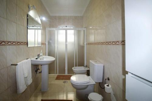 a bathroom with a toilet and a sink at Casa do Lavrador in Ponta Delgada