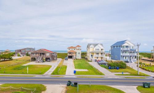 a street in a residential neighborhood with houses at It's A Shore Thing - Nags Head MP 11.5, Ocean View, 130 Yds to Beach, Pool, Hot Tub, Rec Room in Nags Head