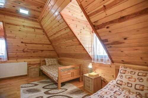 a log cabin with a bed and a window at Vila Sofija Tornik in Ribnica