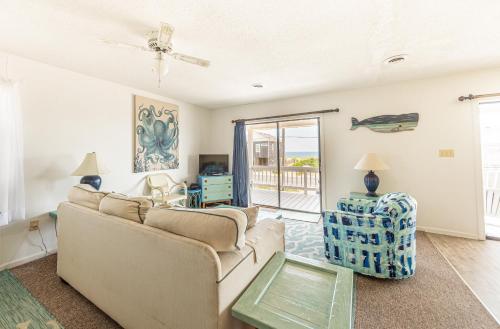 a living room with a couch and a table at Out of the Blue in Kitty Hawk