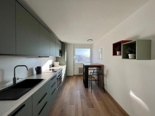 a kitchen with a sink and a counter top at Apartment Popular in Dornbirn