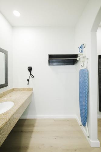 a bathroom with a blue towel hanging on a wall at Sapphire Inn & Suites in Deer Park