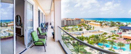 a balcony with a view of the beach and the ocean at Ocean View Penthouse in Palm-Eagle Beach