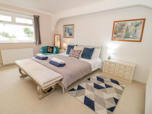 a bedroom with a large bed and a table at Bay Lodge in Amlwch
