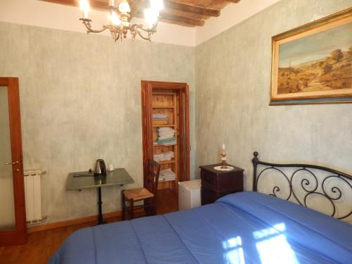 a bedroom with a blue bed and a sink at Agriturismo Fonte Magria in Abbadia San Salvatore