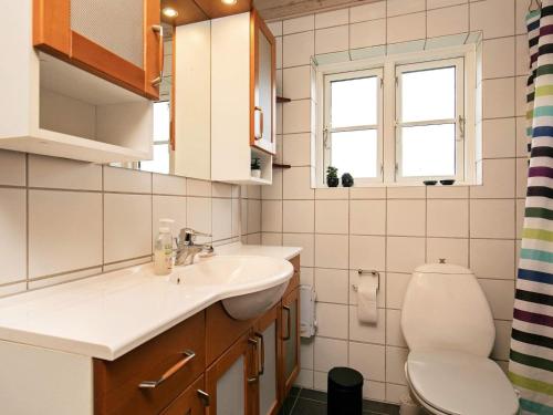 a bathroom with a sink and a toilet at Holiday home Lemvig IV in Ferring