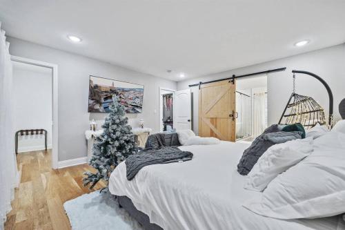 a bedroom with a christmas tree and a large bed at *The 4Seasons:Themed Retreat w/Hot Tub-Pool Table* in Decatur