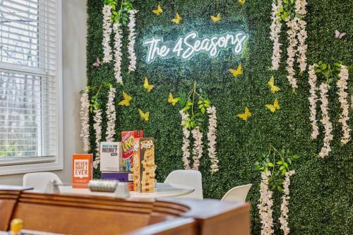 a green wall with a sign that says top agency at *The 4Seasons:Themed Retreat w/Hot Tub-Pool Table* in Decatur
