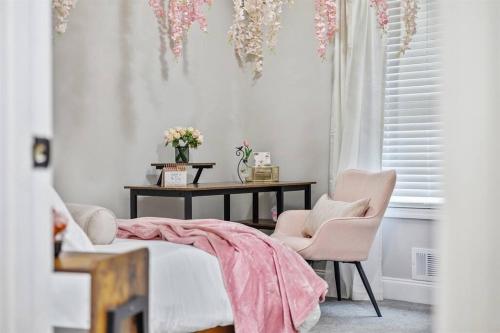 a bedroom with a bed and a table and chairs at *The 4Seasons:Themed Retreat w/Hot Tub-Pool Table* in Decatur
