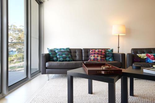 a living room with a couch and a table at Tranquility the Beach in Huskisson