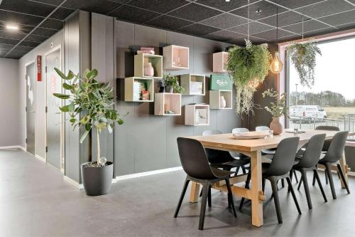 a dining room with a table and chairs at Aiden by Best Western Herning in Herning