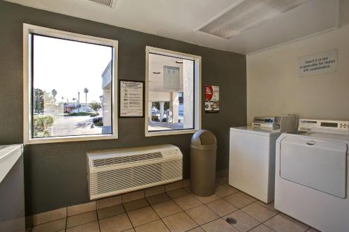 a laundry room with a washer and dryer and a window at Motel 6-Sunnyvale, CA - North in Sunnyvale