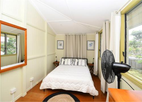 a bedroom with a bed and a window at Torquay Treasure in Torquay