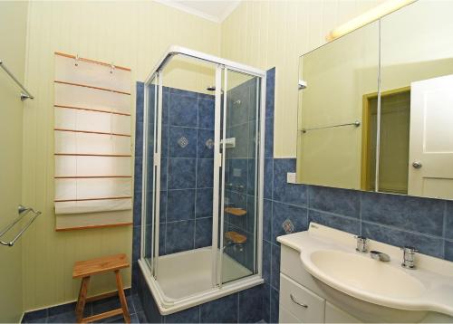 a bathroom with a glass shower and a sink at Torquay Treasure in Torquay
