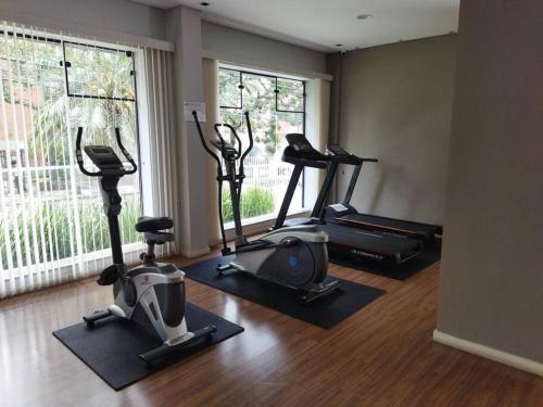 a gym with three exercise bikes and a window at Century Hall in Curitiba