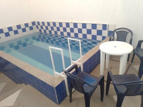 a small swimming pool with a table and chairs at casa turística Mónaco 48 in Carmen de Apicalá