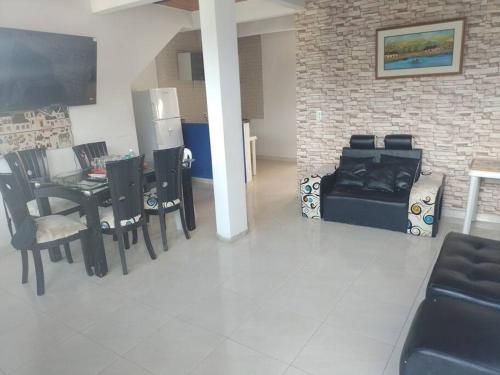 a living room with a table and chairs and a couch at casa turística Mónaco 48 in Carmen de Apicalá