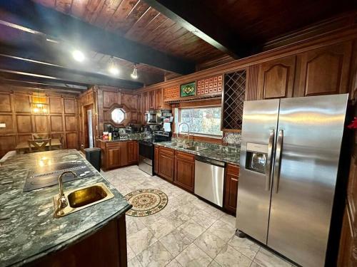 a kitchen with wooden cabinets and a stainless steel refrigerator at 5 Bedroom Estate near Casino and downtown in Bristol
