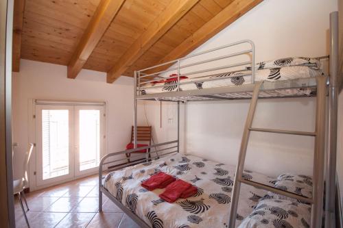 a bedroom with two bunk beds in a room at Casa del Sole - sleeps 4 with shared pool in Pianello Del Lario