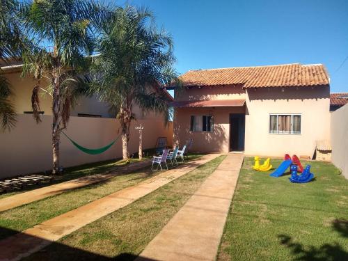 a house with a yard with a playground at Casa Viva Bonito in Bonito