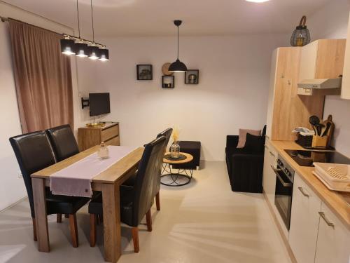a kitchen and dining room with a table and chairs at Apartments by the sea Nevidjane, Pasman - 8453 in Neviđane