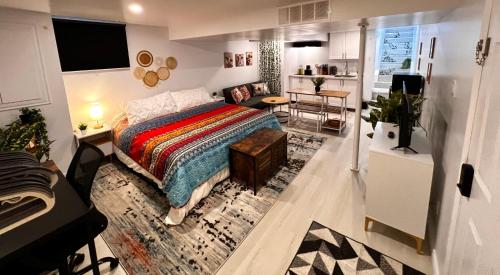 a bedroom with a bed and a desk and a kitchen at The Boho Oasis in Windsor