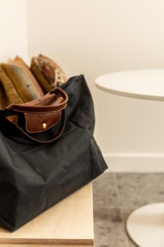 a black bag sitting on top of a table at Petit hôtel de la Montagne in Havre-Aubert