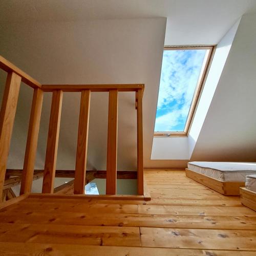 an attic room with a bed and a window at Entire Loft close to Beautiful Logar Valley in Rečica ob Savinji