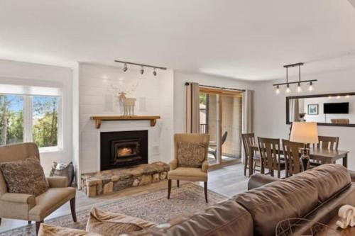 a living room with a couch and a fireplace at Mountainside Cozy Walk to Gondola Hot Tub Condo in Steamboat Springs