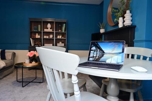 a laptop computer sitting on a white table in a room at Luxury accommodation in Durham centre in Durham