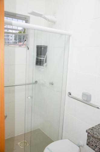 a bathroom with a glass shower with a toilet at Hotel Penha in Penha