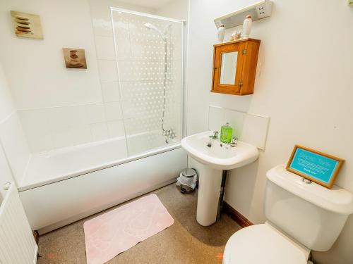 a bathroom with a sink and a toilet and a shower at Pine Cottage - Rchp140 in Calton