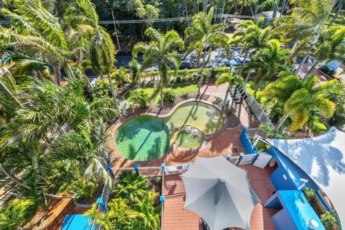 an aerial view of a resort with a pool and palm trees at White Crest Apartments in Hervey Bay