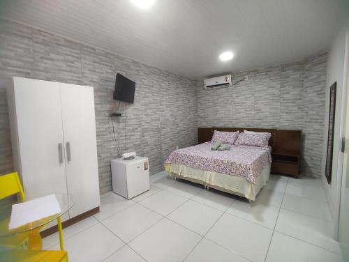 Ein Bett oder Betten in einem Zimmer der Unterkunft Pousada Marihá