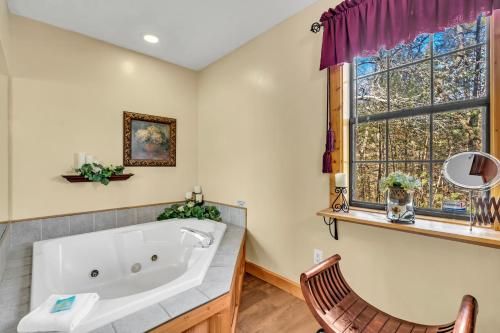 a bathroom with a large tub and a window at Amberwood- Get 951 worth of FREE area attraction tickets for each paid day!!! in Sevierville