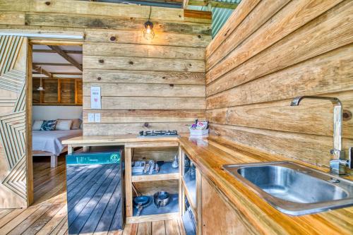 a kitchen with a sink in a tiny house at Monkey Tiny House - Private swimming pool in Big Bight