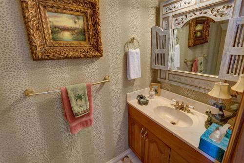 a bathroom with a sink and a mirror at Lovely Gulf View Walk To Beach All Appliances in Bradenton Beach