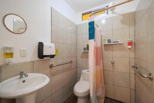a bathroom with a toilet and a sink at Hotel Boutique D Angelo in Manzanillo