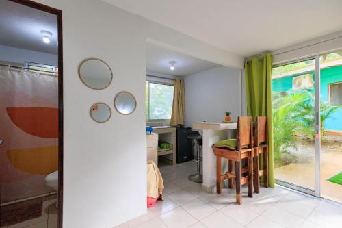 a bathroom with a sink and a desk with a mirror at Hotel Boutique D Angelo in Manzanillo